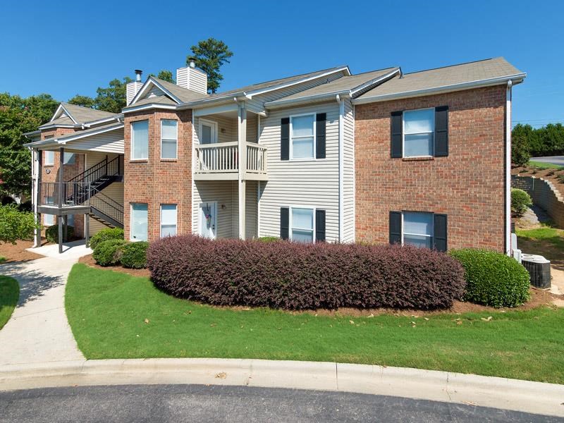 Concrete walkway with lush landscaping through Chace Lake Villas apartments in Birmingham, AL Concrete walkway with lush landscaping through Chace Lake Villas apartments in Birmingham, AL